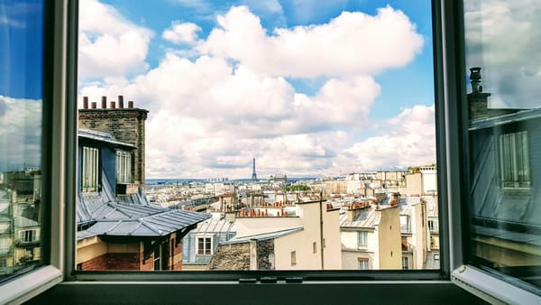 Photo of open windows and a city skyline