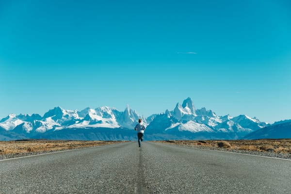A person running in front of a mountain range